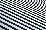 A diagonal photo of tiling in the pattern of black and white zebra stripes.