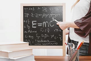 woman writing on a blackboard