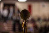 Microphone in front of blurry audience