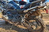 Closeup of mud- and sand-splattered motorcycle. If you think there’s a lot of dirt on this motorcycle, you should have seen the rider!