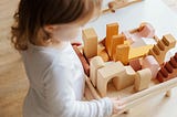Free Play / Photo by Tatiana Syrikova: https://www.pexels.com/photo/unrecognizable-little-girl-playing-with-wooden-blocks-at-table-at-home-3933033/