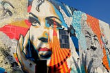 Colorful painted portrait of a woman on a city building, Street art