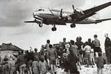 Historic image of C54 flying into Berlin over the heads of onlookers