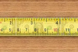 A tape measure that stretches out and appears to measure dollars
