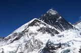 An image of snowy mountain peaks and deep blue sky.