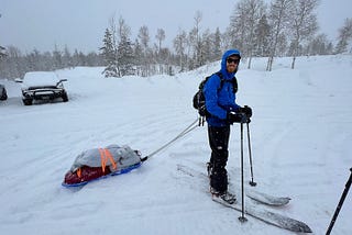 Splitboarder pulling sled or pulk to Boundary Creek Yurt in the Uintas