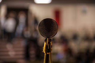 Microphone in front of blurry audience