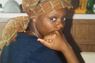 Tween Black girl in headscarf looking anxious