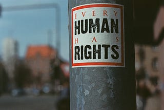 A sign on a pole reading Every Human Has Rights