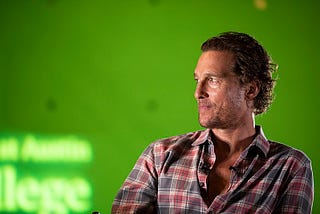 Matthew McConaughey in front of a green backdrop.