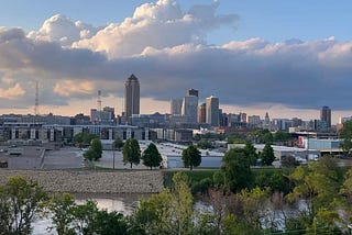 Skyline view of downtown of a small city. Clouds in the backdrop just before dusk sets in.