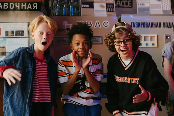 A diverse trio of pre-teen boys react to a pleasant surprise.